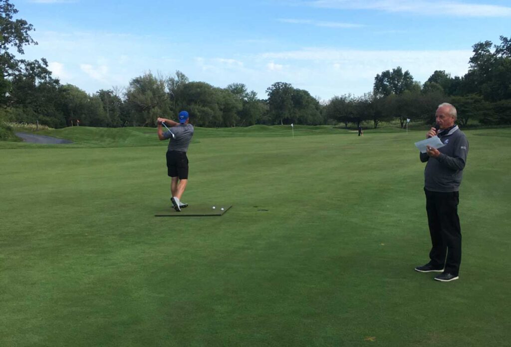 A golfer takes a swing at Black River golf course during charity event.